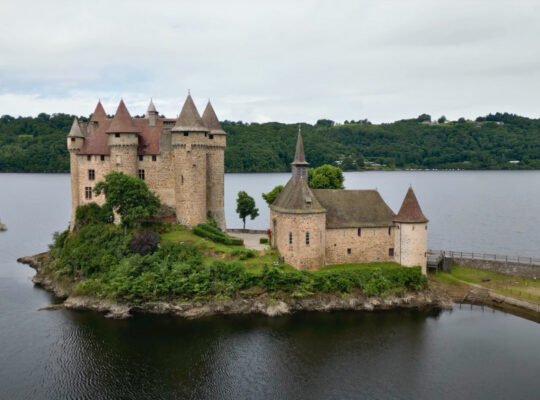 Chateau de Val on small island surrounded by calm lake