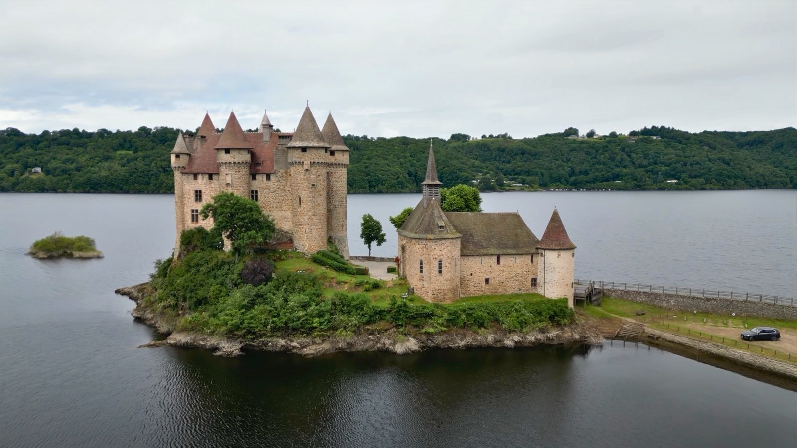 Chateau de Val on small island surrounded by calm lake
