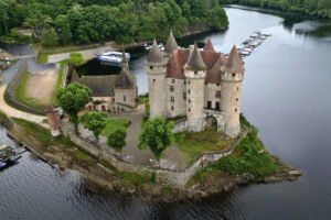 Aerial view of Chateau de Val beside lake