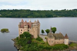 Chateau de Val perched on a small island overlooking a tranquil lake