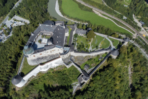 Aerial photo of Hohenwerfen Fortress on a rocky ridge above the Salzach River near Werfen, Austria.