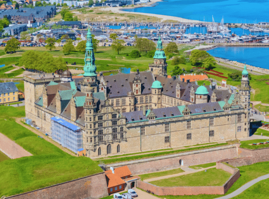 Aerial view of Kronborg Castle in Helsingør, Denmark, beside the marina and Øresund coast.