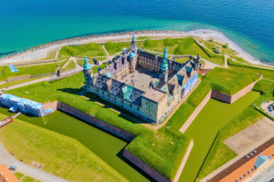 Aerial view of Kronborg Castle in Helsingør, Denmark, with star-shaped fortifications and moat by the Øresund.
