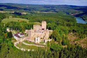 Aerial view of Landštejn Castle surrounded by forest and lakes