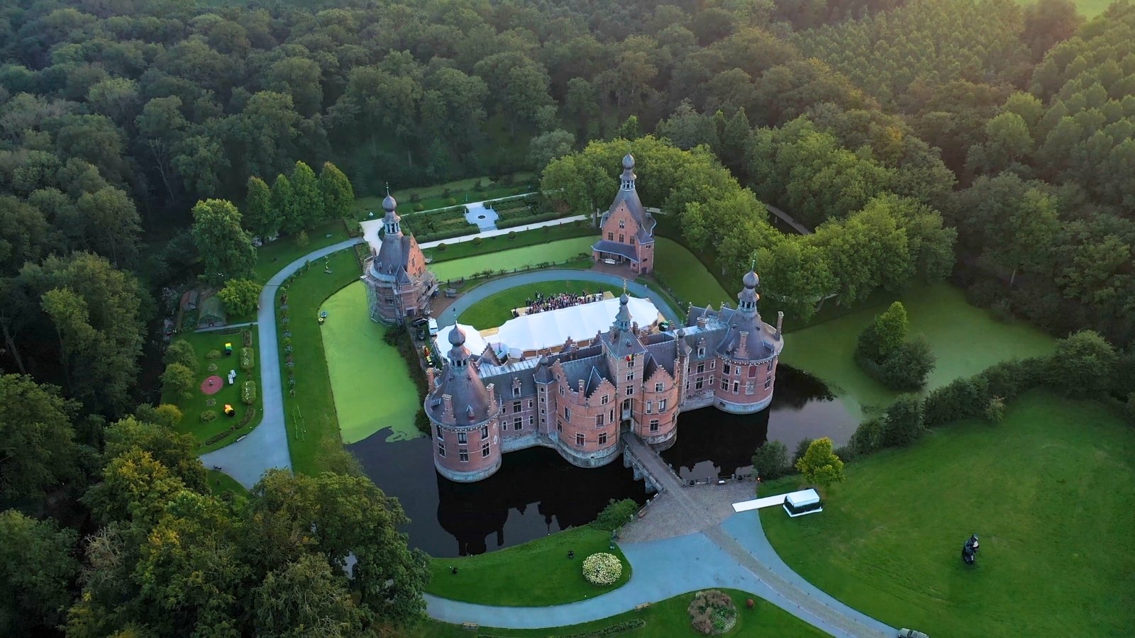 Aerial view of Ooidonk Castle surrounded by moat and forest