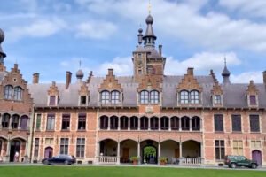 Ooidonk Castle façade and tower under blue sky