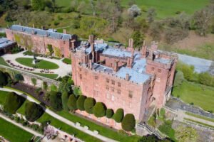 Aerial view of Powis Castle with terraced gardens and yews