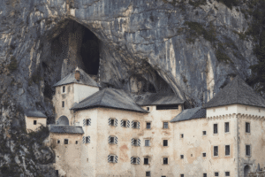 Predjama Castle in Slovenia, a medieval fortress dramatically built into a limestone cliff and cavern.