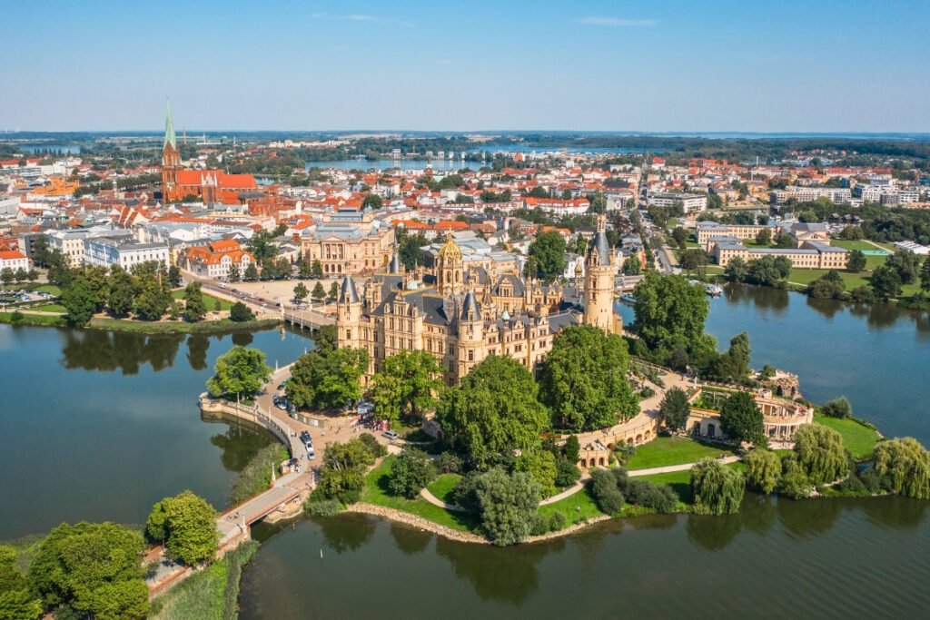 Aerial view of Schwerin Castle surrounded by lake and city