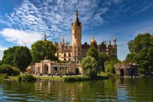 Schwerin Castle reflected in calm lake with turrets and sky
