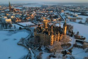 Aerial view of Schwerin Castle on snowy island at sunrise