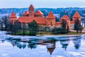 Trakai Island Castle on Lake Galvė with icy reflections.
