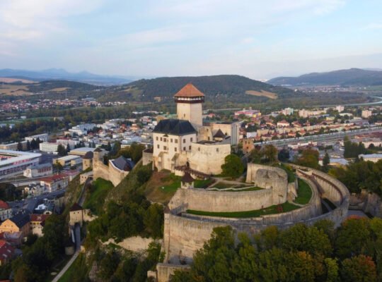 Aerial view of Trenčín Castle perched above town and stadium