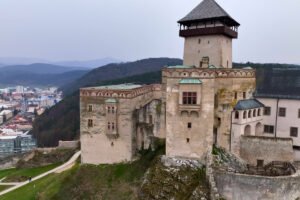 Trencin Castle on rocky hill above town and forested hills