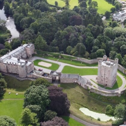 Aerial view of Appleby Castle surrounded by trees and river