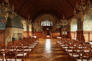 Interior of Bouzov Castle great hall with chandeliers and wooden vaulted ceiling