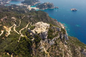 Aerial view of Castello bizantino di Angelokastro perched on coastal cliff above Ionian Sea