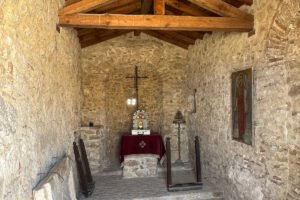 Interior chapel altar at Castello bizantino di Angelokastro with stone walls and wooden beams