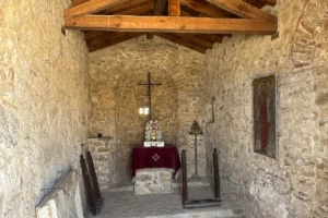 Interior chapel altar at Castello bizantino di Angelokastro with stone walls and wooden beams