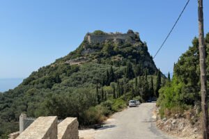 Hilltop Castello bizantino di Angelokastro above olive groves and coastal road