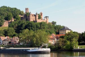 Castle Wertheim rising above riverside town and barge