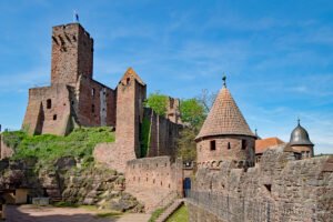 Castle Wertheim ruins on hill with towers under blue sky