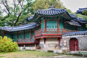 Traditional Korean pavilion at Changdeokgung Palace with green lattice doors and tiled roof