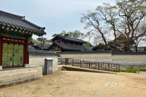 Changdeokgung Palace traditional roofs and garden walls under spring sky