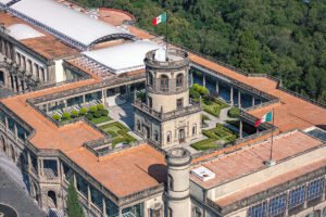 Aerial view of Chapultepec Castle rooftop gardens and Mexican flag
