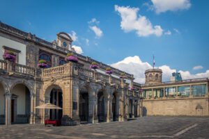 Chapultepec Castle stone arcade and balcony under bright blue sky