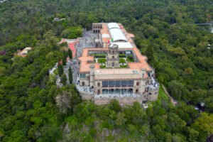 Aerial view of Chapultepec Castle perched above lush forest in Mexico City
