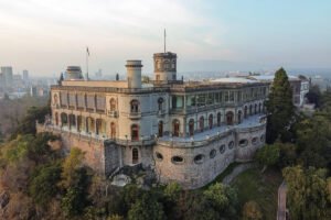 Chapultepec Castle perched on hilltop with city skyline behind