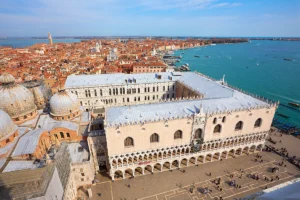 Aerial shot of the Doge's Palace and Venetian lagoon, rooftops and domes
