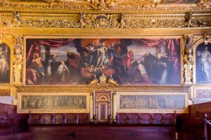 Ornate council chamber interior at the Doge's Palace with gilded ceiling and paintings