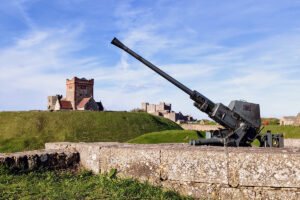 Dover Castle seen from ramparts with historic coastal artillery gun in foreground