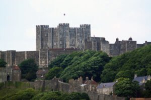 Dover Castle atop green cliffs, stone keep visible