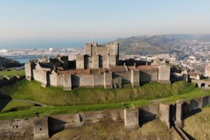 Aerial view of Dover Castle perched above the white cliffs and harbor