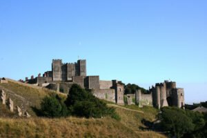 Dover Castle perched above grassy cliffs under clear blue sky