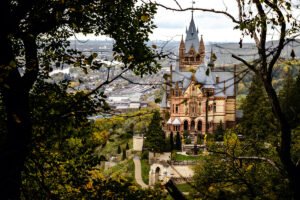 View of Drachenburg Castle framed by trees on hillside