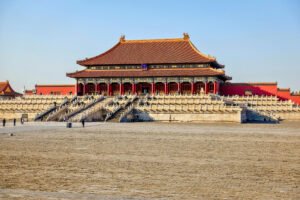 Forbidden City palace facade and wide courtyard under clear sky