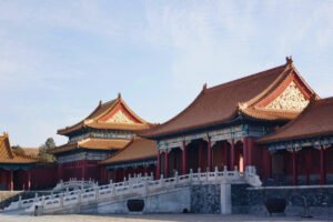 Forbidden City ornate rooftops and marble balustrade under blue sky
