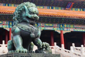 Bronze guardian lion statue at the Forbidden City entrance