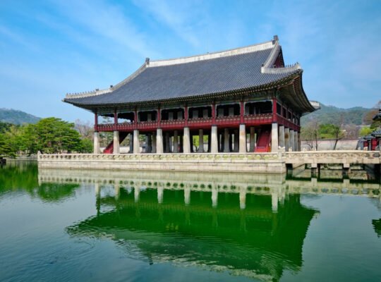 Gyeongbokgung Palace pavilion reflected in green pond