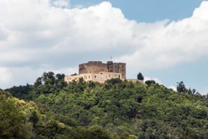 Hambach Castle perched on green hill under cloudy sky