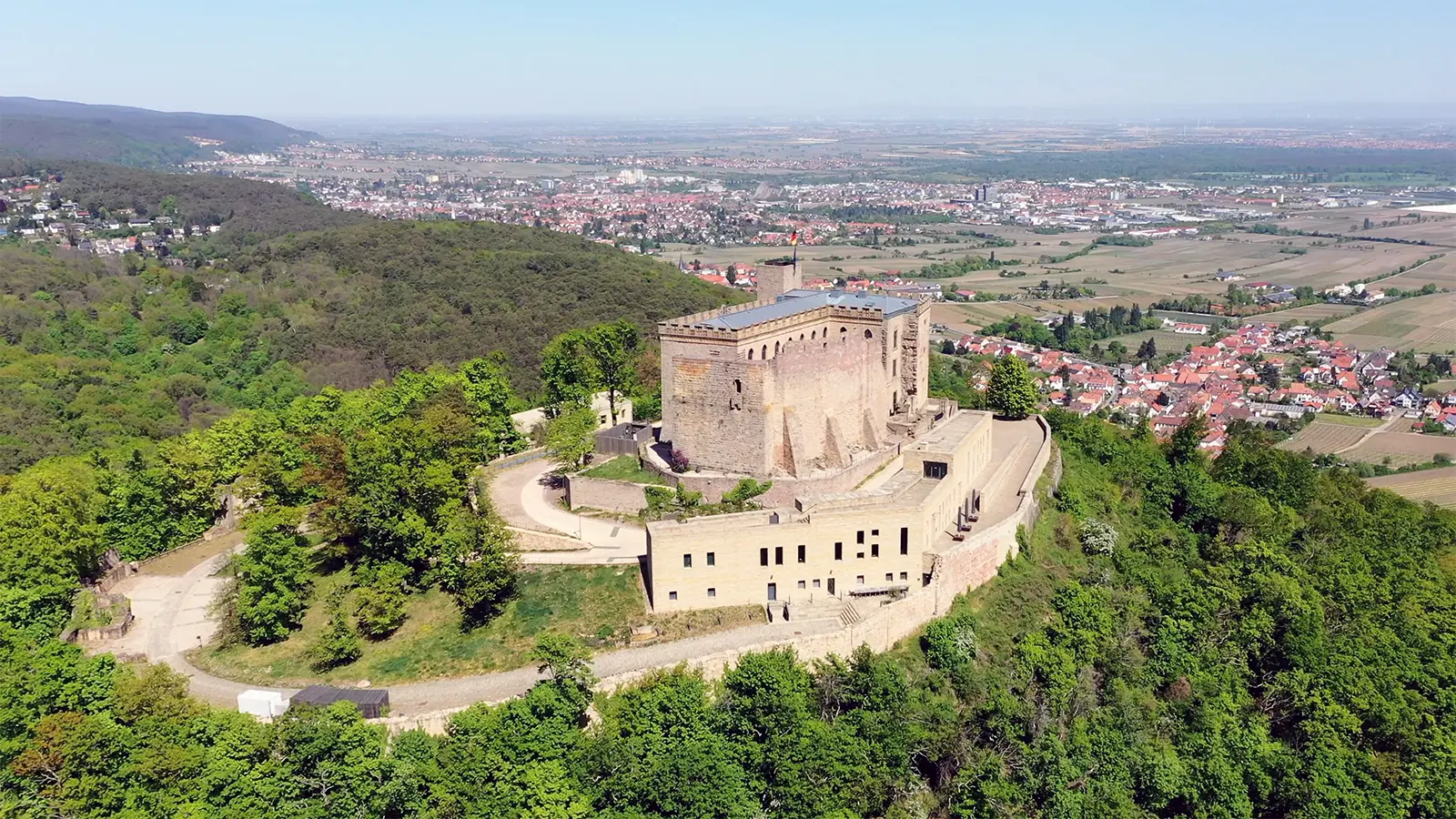 Aerial view of Hambach Castle on wooded hill above Palatinate plains