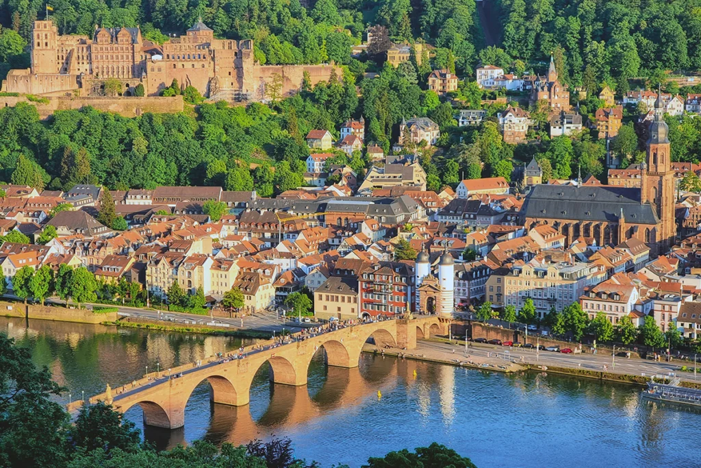Heidelberg Castle above Neckar River with historic Old Bridge in foreground