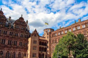 Heidelberg Castle courtyard and red sandstone façades under blue sky