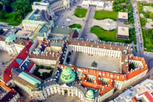 Aerial view of Hofburg Palace courtyard and domed roofs in Vienna