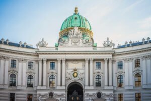 Hofburg Palace facade with green dome and ornate sculptures, Vienna