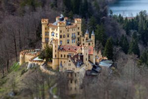 Hohenschwangau Castle perched above forest and lake